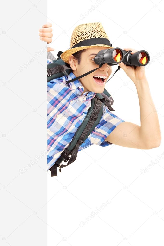 Male tourist looking through binocular