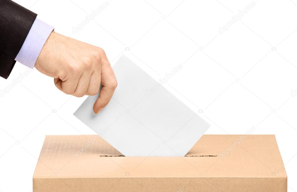 Hand putting voting ballot in box