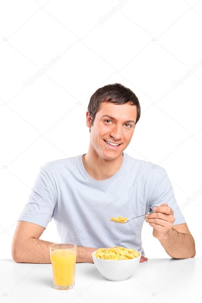 Man eating cornflakes at breakfast