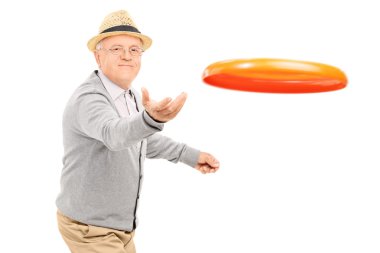 Senior man throwing a Frisbee disk  clipart