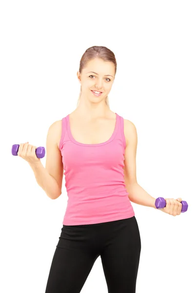 Young female excercising with dumbbells — Stock Photo, Image