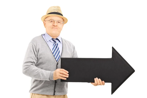 Senior gentleman holding black arrow — Stock Photo, Image