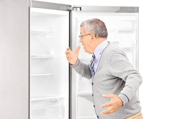 Hombre sorprendido mirando en nevera vacía — Foto de Stock