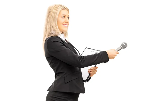 Female interviewer holding a microphone — Stock Photo, Image