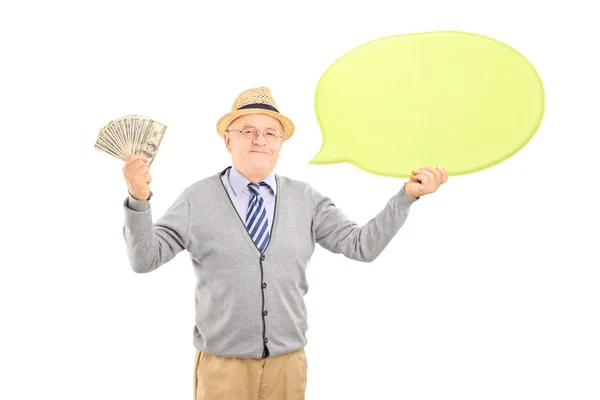 Cavalheiro segurando uma bolha de discurso e dólares — Fotografia de Stock