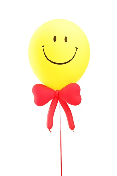 Veselý obličej balónem s červeným motýlkem — Stock fotografie