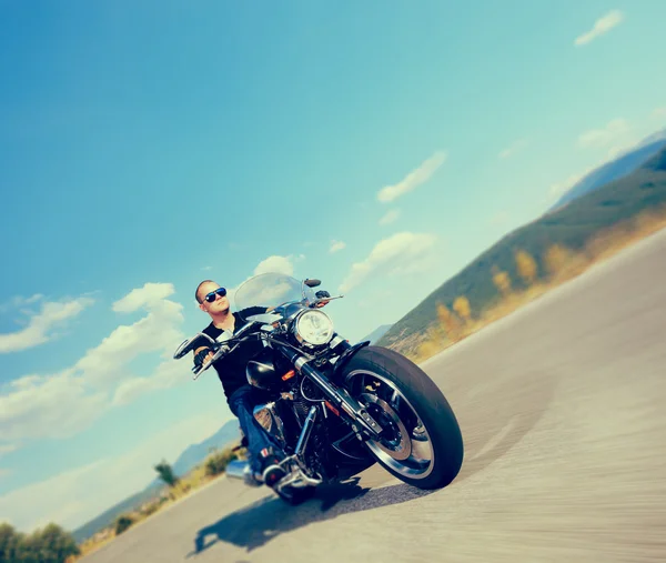 Biker riding customized motorcycle — Stock Photo, Image