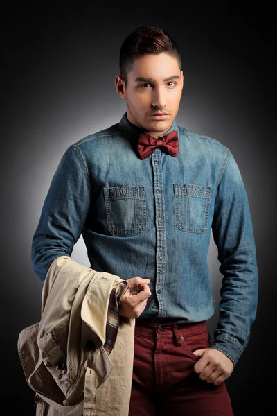 Male model holding coat — Stock Photo, Image