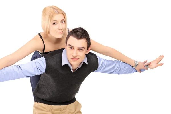 Happy young couple posing piggyback — Stock Photo, Image