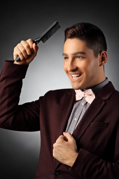 Stylish man holding comb — Stock Photo, Image