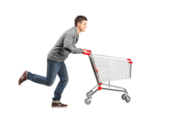 Man pushing an empty shopping cart