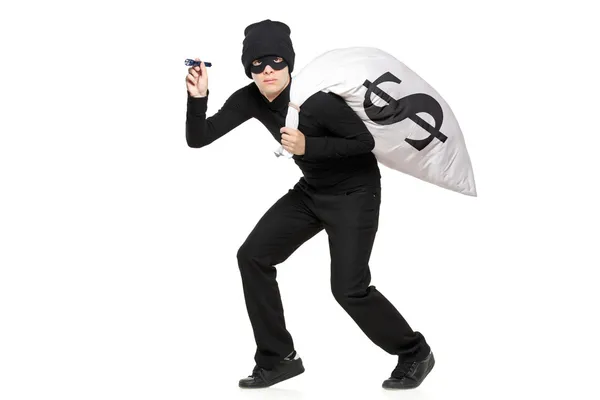 Thief with bag and flashlight — Stock Photo, Image