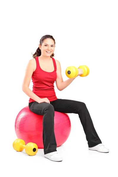 Teenager lifting up dumbbell — Stock Photo, Image