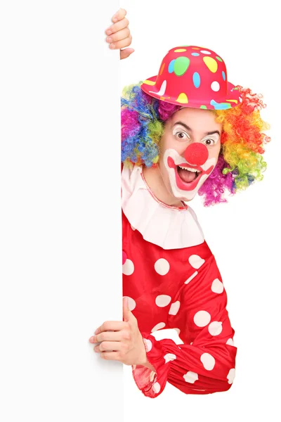 Clown posing behind panel — Stock Photo, Image