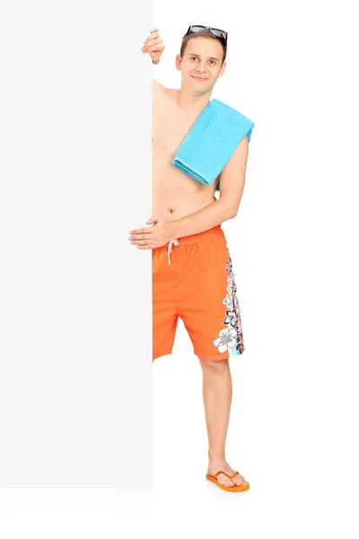 Man in swimsuit behind black panel — Stock Photo, Image