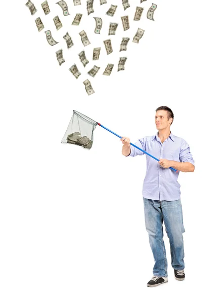 Человек собирает доллары с рыболовной сетью — стоковое фото