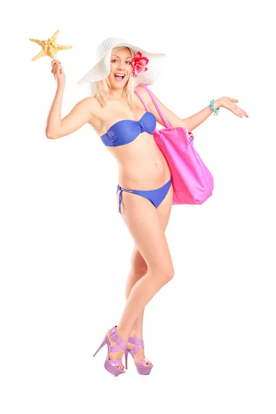Frau im Bikini hält Seesterne in der Hand — Stockfoto