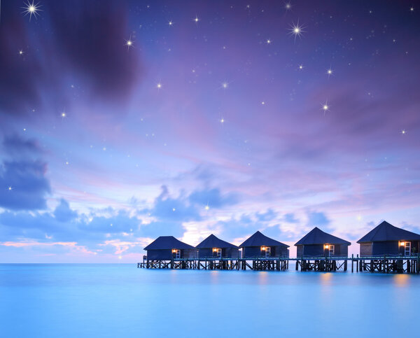 Starry skies over water villa cottages