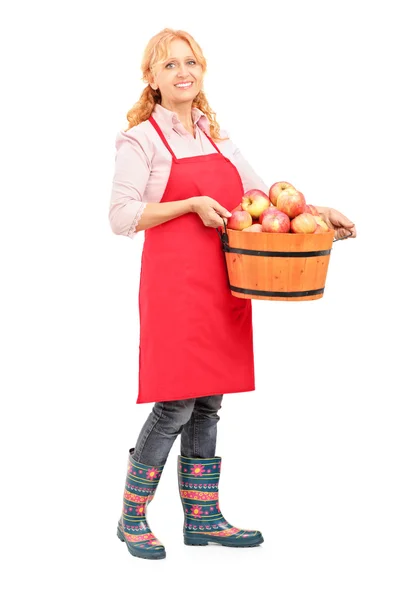 Woman with apron holding bucket full — Stock Photo, Image