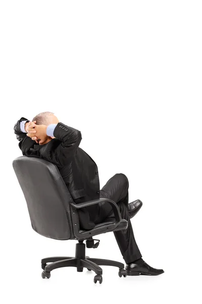 Mature businessman resting in armchair — Stock Photo, Image