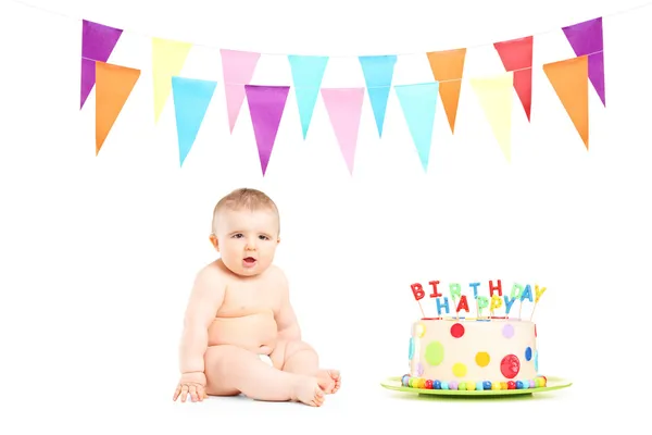 Baby boy next to birthday cake — Stock Photo, Image