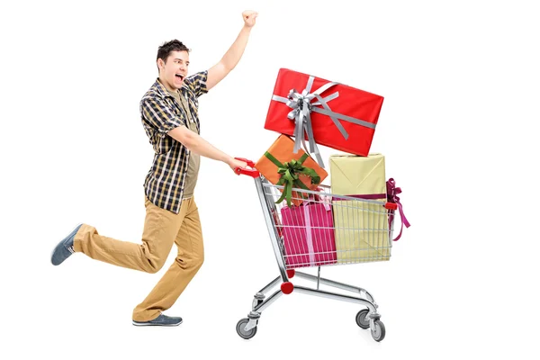 Homem feliz empurrando carrinho de compras — Fotografia de Stock