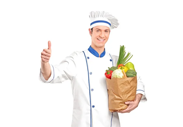 Chef dando pulgar hacia arriba y sosteniendo una bolsa de comestibles — Foto de Stock