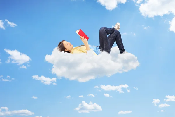 Female reading a novel on clouds — Stock Photo, Image