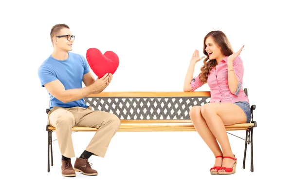 Man giving a heart to a surprised female — Stock Photo, Image
