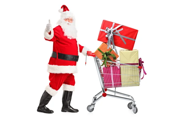 Санта Клаус толкает корзину — стоковое фото