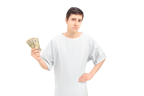 Paciente masculino segurando dólares americanos — Fotografia de Stock