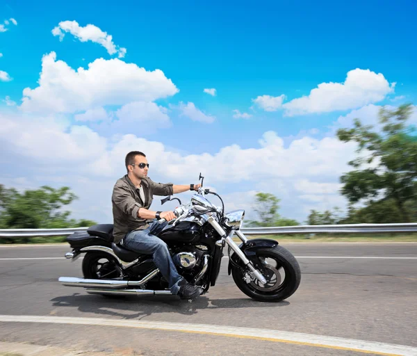 Man riding motorcycle on road — Stock Photo, Image