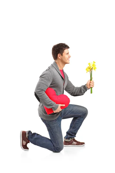 Man holding heart shaped pillow — Stock Photo, Image