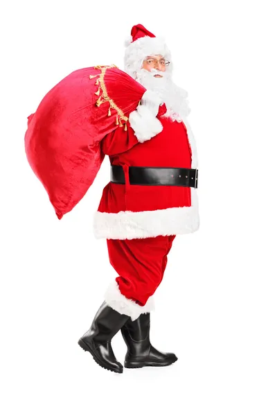 Papai Noel andando com saco — Fotografia de Stock