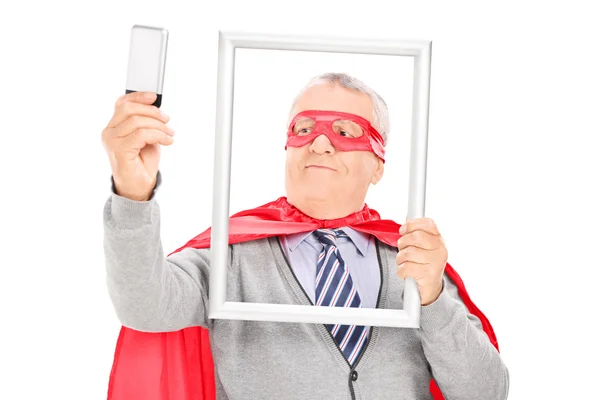 Mature superhero taking a selfie — Stock Photo, Image