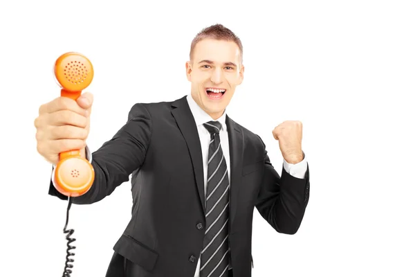 Muž drží telefonní trubici a usmívá se — Stock fotografie