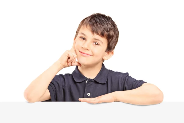 Boy posing behind blank panel — Stock Photo, Image