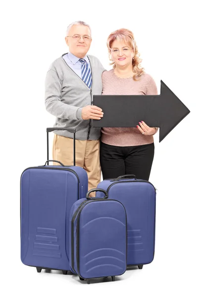 Tourists holding arrow and bag — Stock Photo, Image