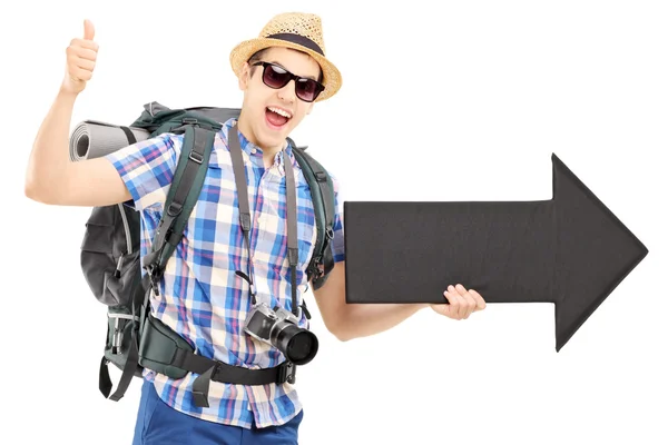 Tourist holding arrow — Stock Photo, Image