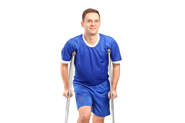 Football player on crutches — Stock Photo, Image