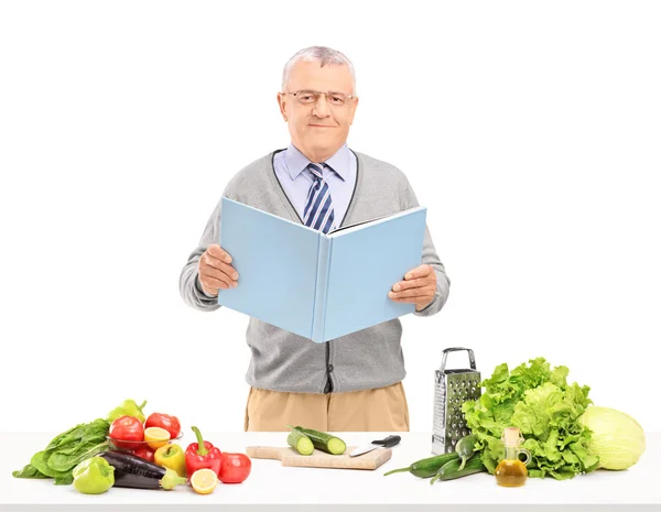 Gentleman reading cookbook — Stock Photo, Image
