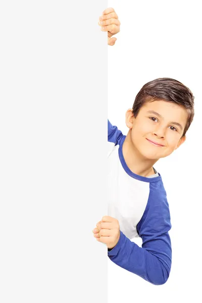 Young child standing behind blank panel — Stock Photo, Image