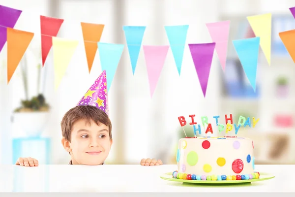 Хлопчик дивиться на торт на день народження — стокове фото
