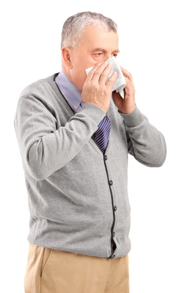Man blowing his nose in tissue — Stock Photo, Image