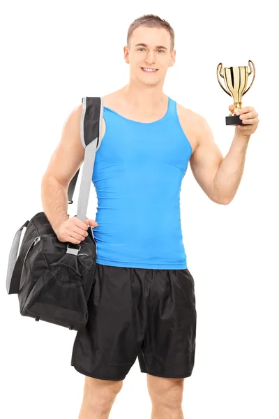 Homem com saco desportivo e um troféu — Fotografia de Stock