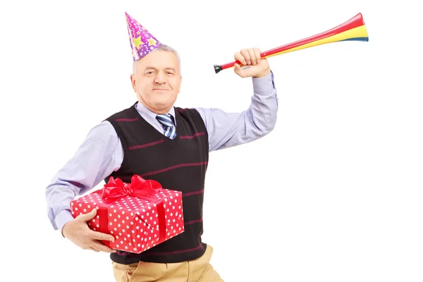 Man holding gift and horn — Stock Photo, Image