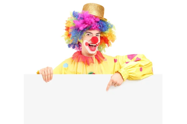 Clown pointing on blank panel — Stock Photo, Image