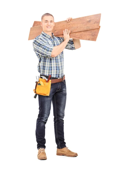 Male carpenter carrying planks — Stock Photo, Image