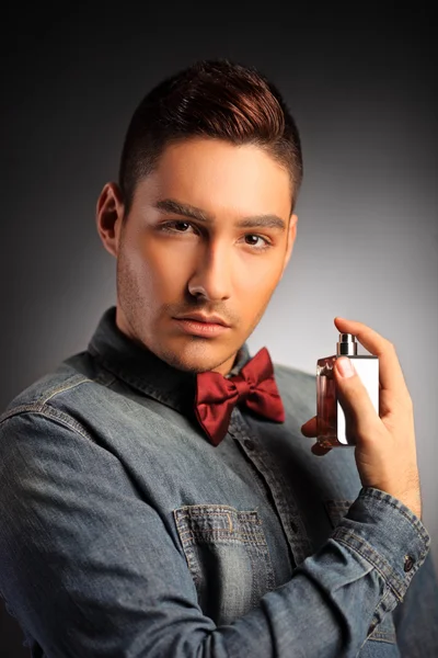 Handsome male applying perfume — Stock Photo, Image