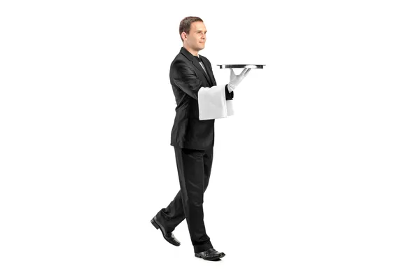Young butler carrying tray — Stock Photo, Image